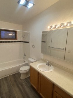A bathroom with a toilet, sink, and mirror.