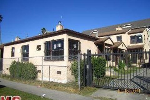 A house with a black fence in front of it.