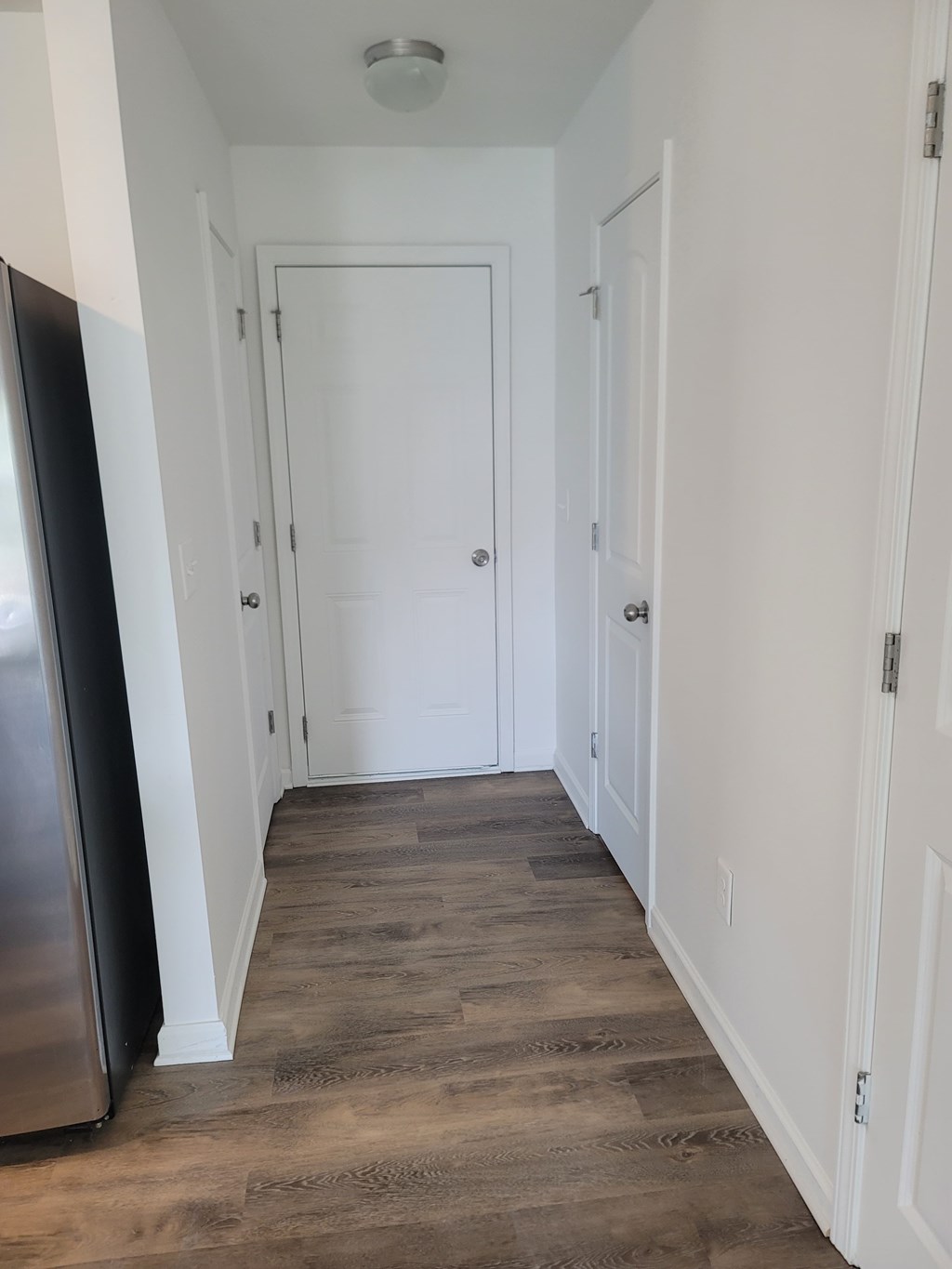 A long hallway with a door at the end.