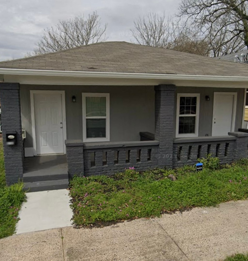 A house with a grey roof and white door.