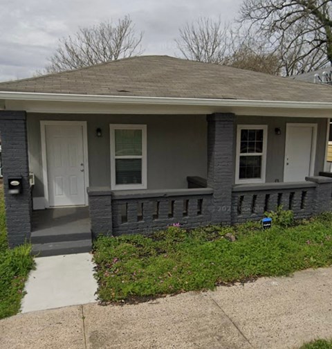A house with a grey roof and white door.