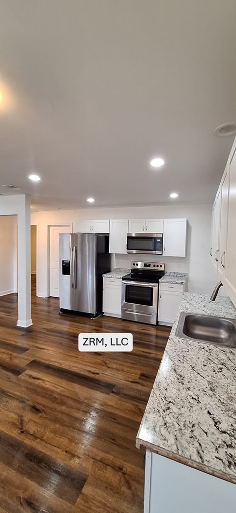 A modern kitchen with a sink and a refrigerator.