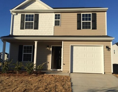 A two-story house with a white garage door.