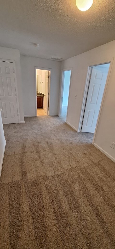 A room with carpeted floor and white walls.