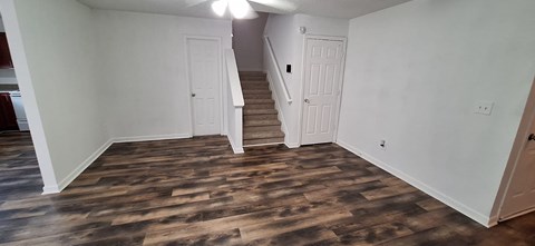 A room with wooden floors and white walls.