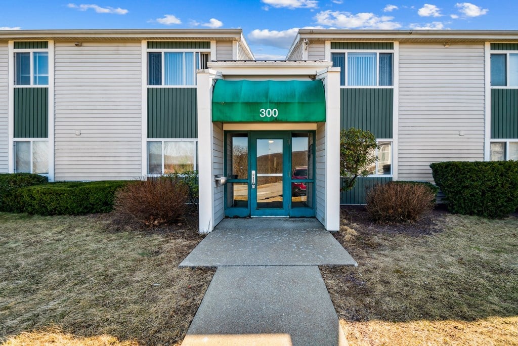 The front of a building with a green awning and the number 300 on it.