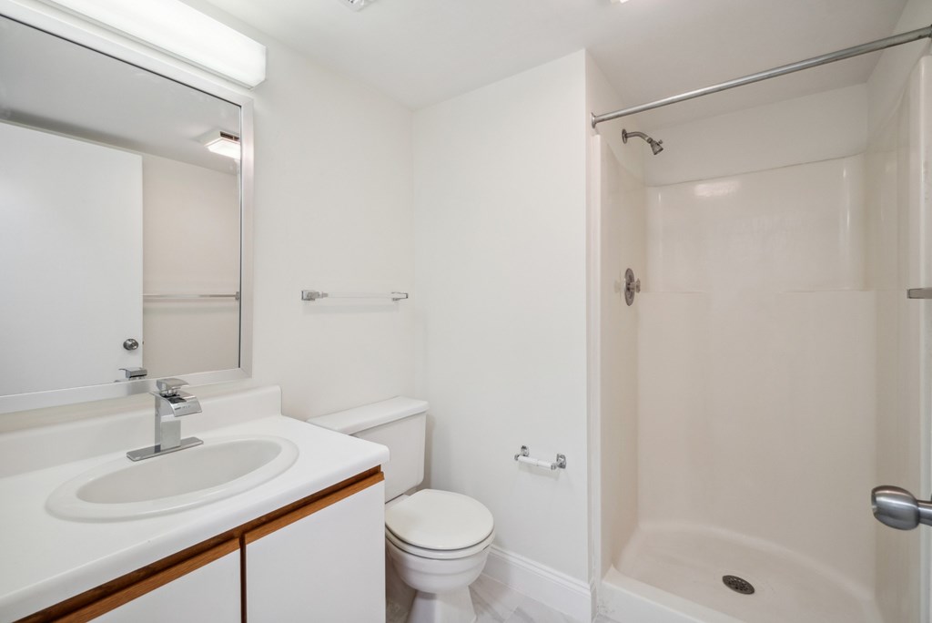 A white bathroom with a sink, toilet, and bathtub.