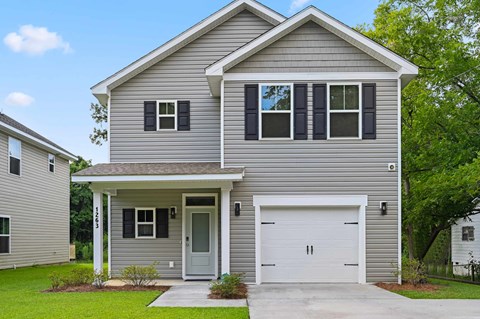 A two-story house with a garage and a front porch.