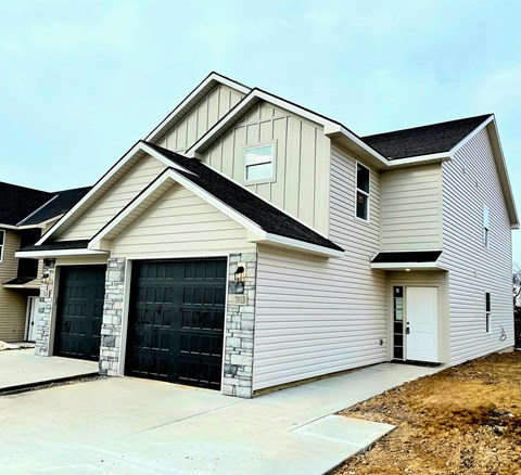 A two-story house with a garage on the first floor.