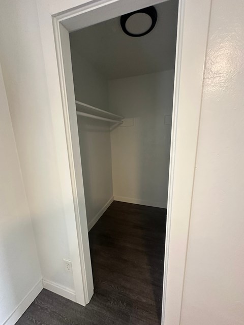 A white doorway leads to a dark room.
