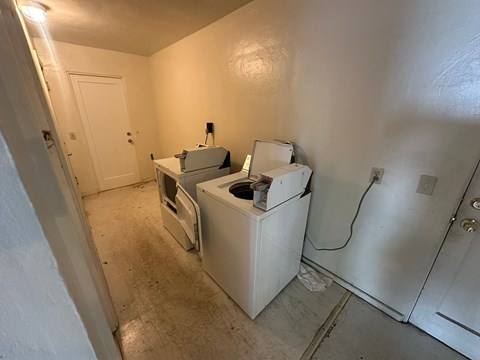 A room with a washing machine and dryer in it.