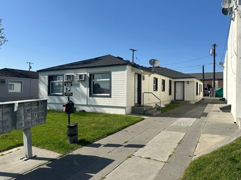 A row of mobile homes with a mailbox in front.
