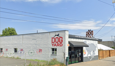 A building with a sign that says Dog Yard.