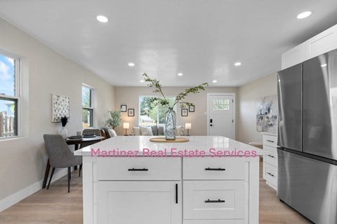 A modern kitchen with a dining area and a large island.