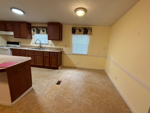 A kitchen with brown cabinets and a countertop.