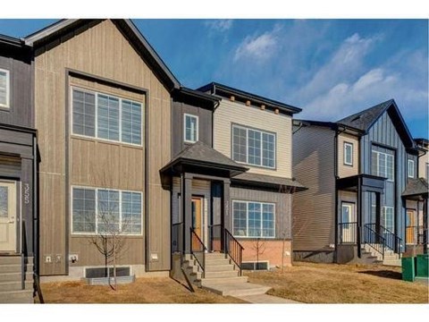 A row of modern houses with different colored exteriors.
