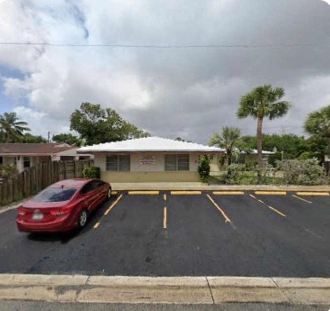 A red car is parked in a parking lot.