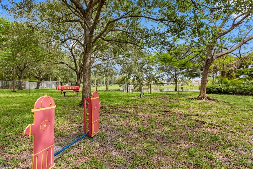 A playground with a red slide and a blue rope.
