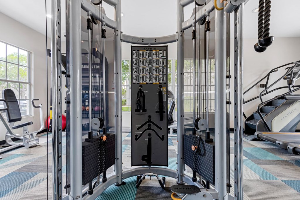 A gym with a variety of equipment including a squat rack.