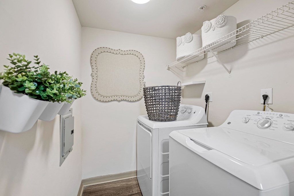 A small white laundry room with a washer and dryer.