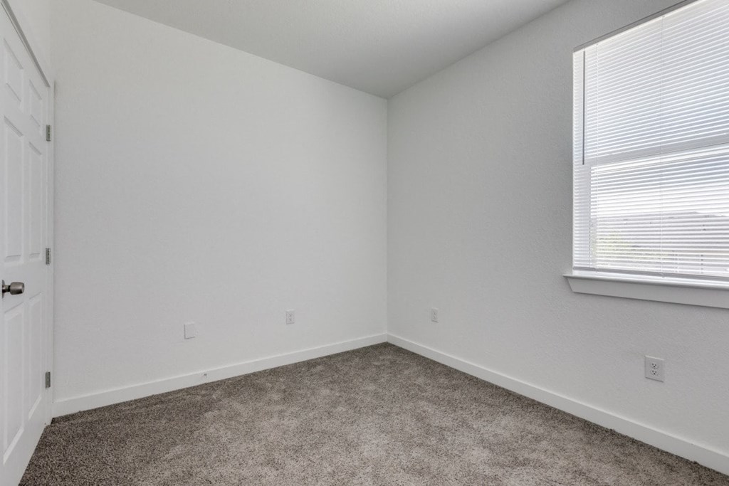 A room with white walls and a carpeted floor.