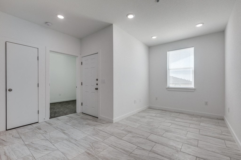 A room with a tiled floor and a window.