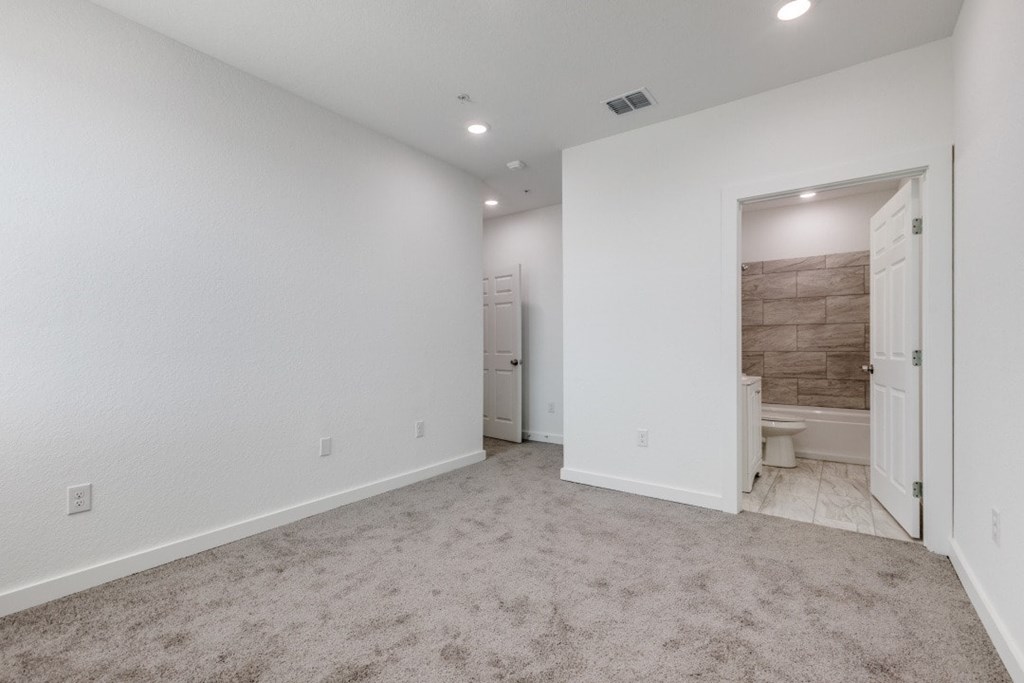 A room with white walls and a carpeted floor.