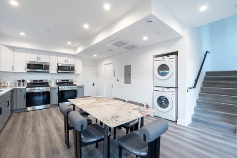 A modern kitchen with a large island and stainless steel appliances.