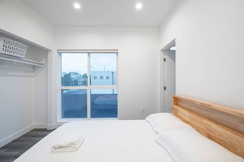 A bedroom with a large bed and a view of the outside.