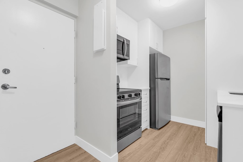 A kitchen with a stove, oven, and refrigerator.