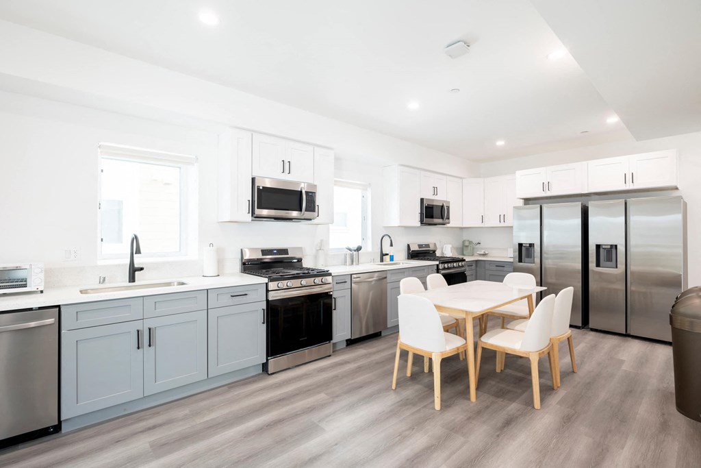 A modern kitchen with a dining table and chairs.
