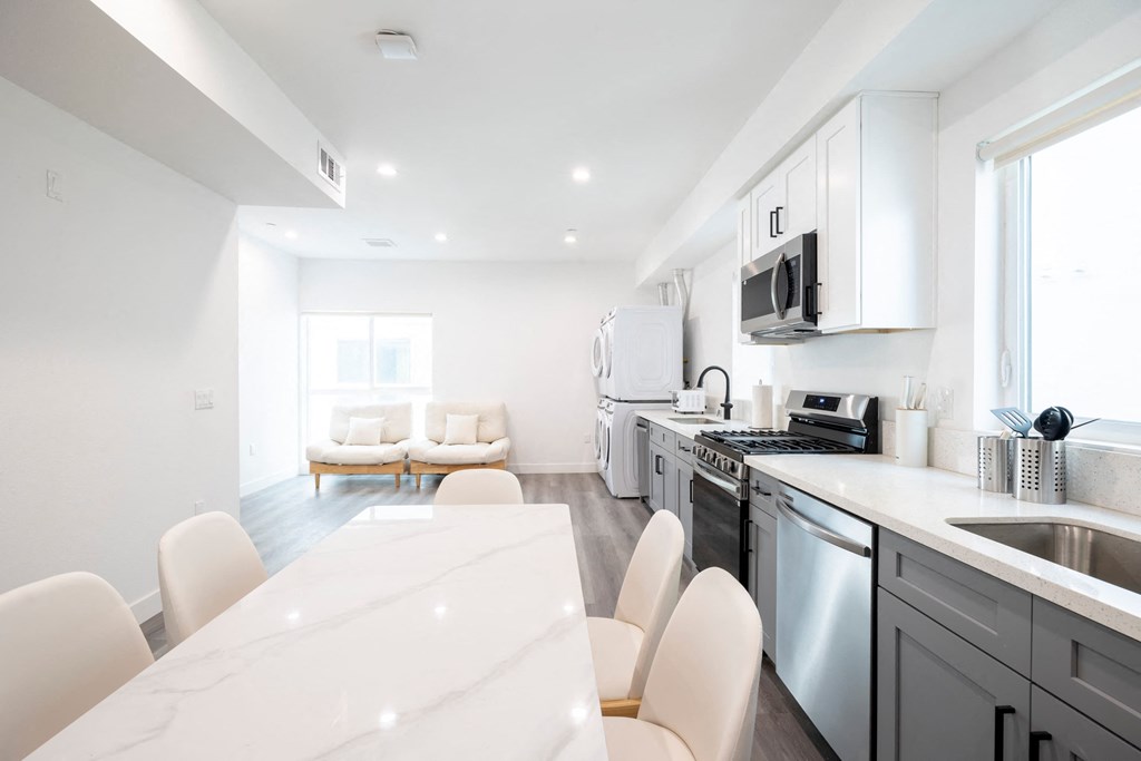 A modern kitchen with a dining table and chairs.