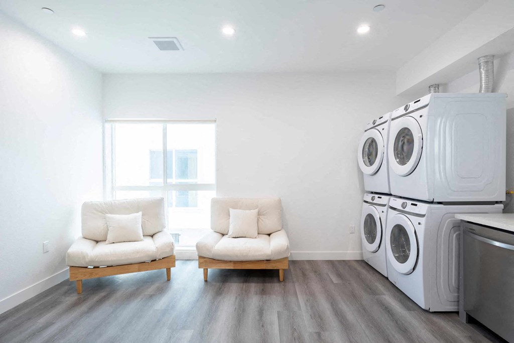 A laundry room with a washer and dryer stacked on top of each other.