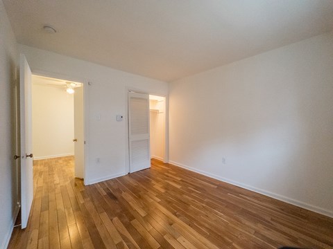 A room with wooden floors and white walls.