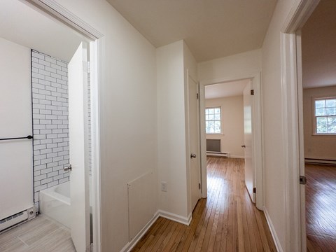 A white bathroom with a tub and a walk in shower.