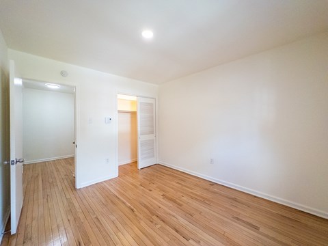 A room with wooden floors and white walls.