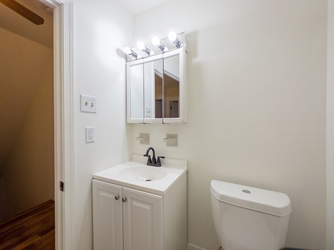 A white sink and toilet in a small bathroom.