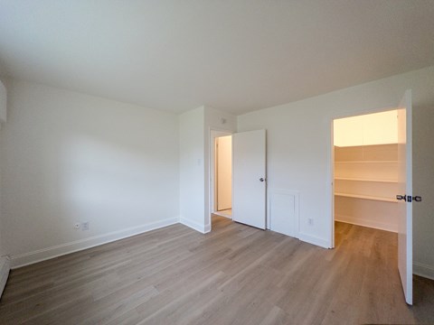 A room with a white door and a white wall.