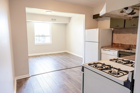A kitchen with a white stove and a window.