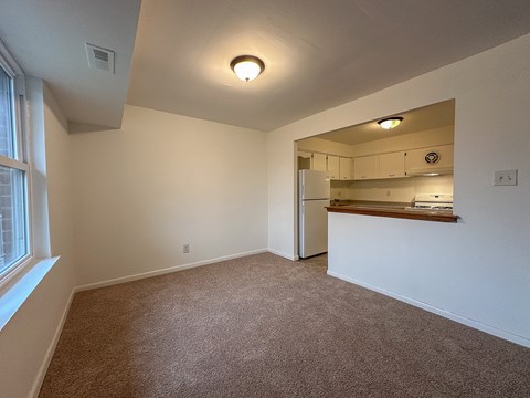 A room with wooden flooring and white walls.