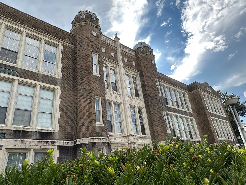 A large, old building with a tower and many windows.