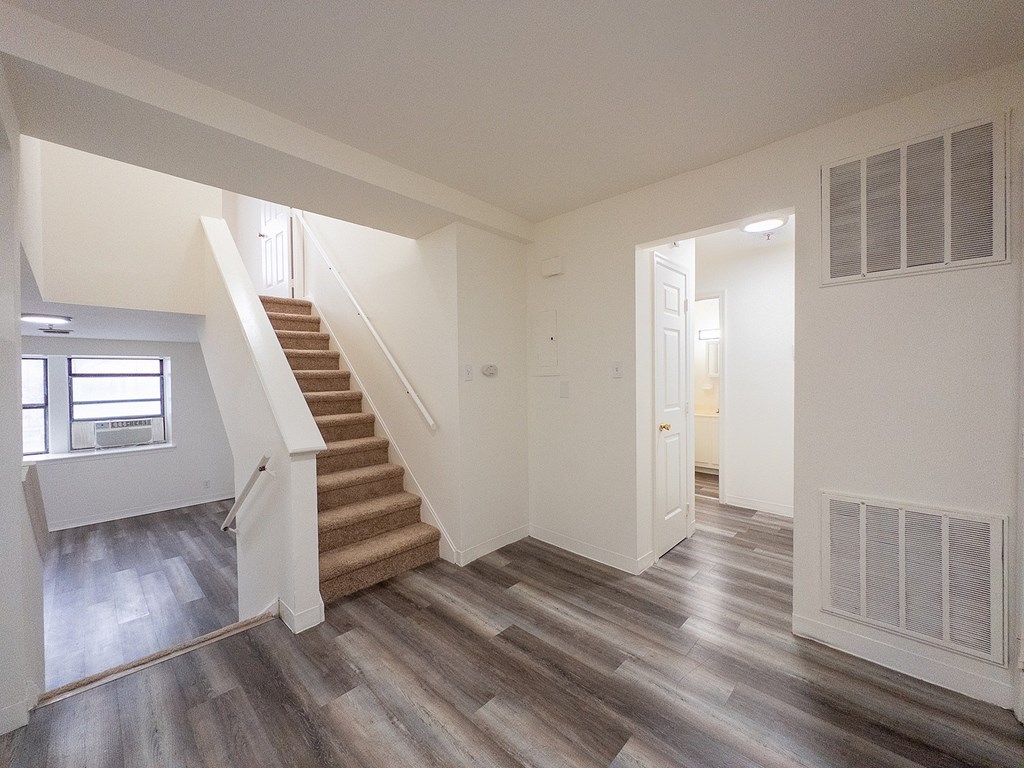 A room with wooden floors and a window.