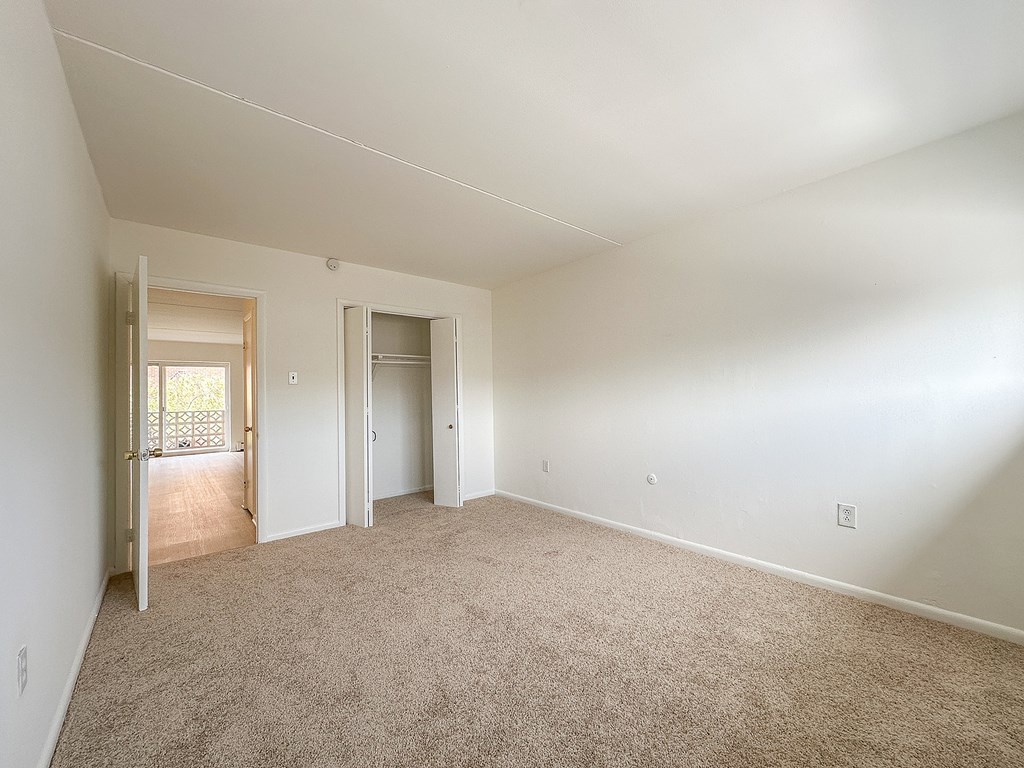 A room with carpeted floor and white walls.