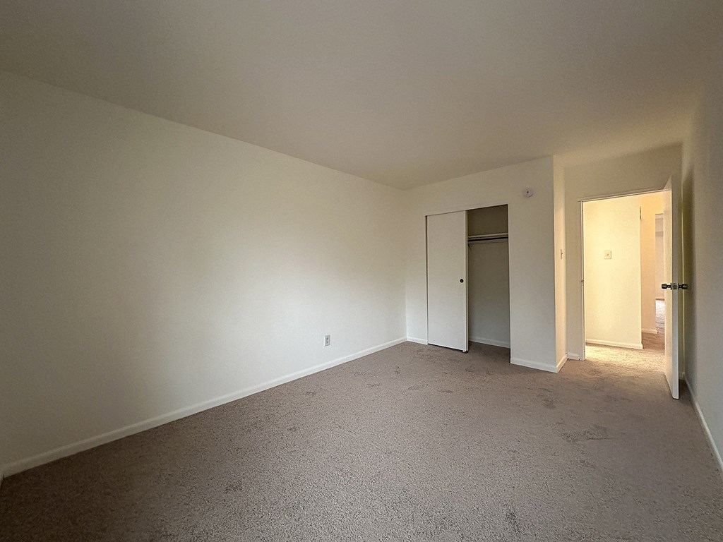 A room with carpeted floor and white walls.