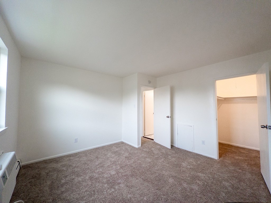 A room with carpeted floor and white walls.