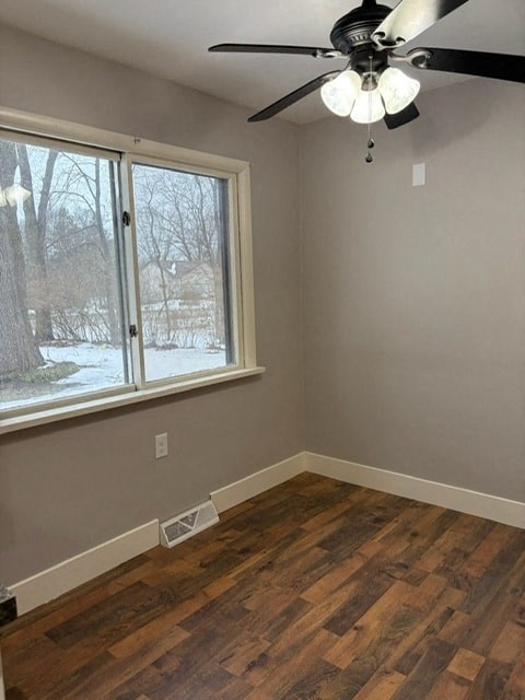 A room with a ceiling fan and a window.