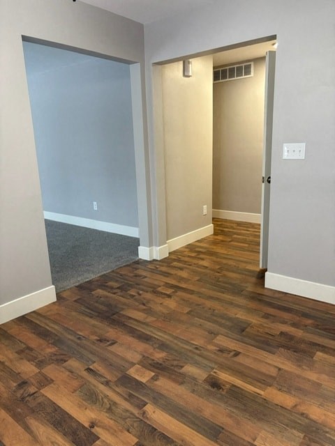 A room with a wooden floor and a sliding door.