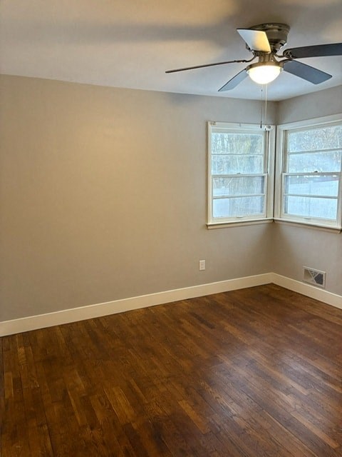 A room with a ceiling fan and a window.