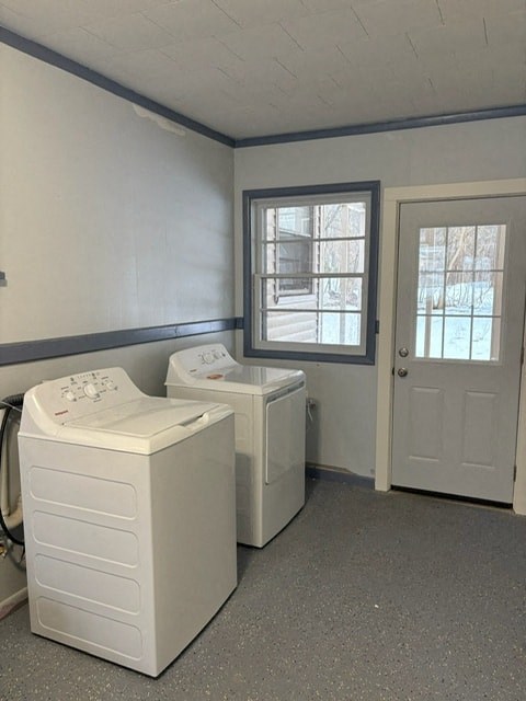 A laundry room with two washers and a dryer.