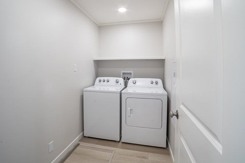 A white washer and dryer in a small laundry room.